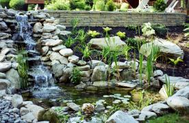 Aquascape Ecosystem Pond with cascading waterfalls built by Certified Aquascape Contractor and pond builder Kingdom Landscaping in Hagerstown Maryland