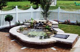 Aquascape Ecosystem Pond built by Certified Aquascape Contractor and Pond Builder Kingdom Landscaping on a patio surrounded by a retaining wall enclosure with a formal look located in Hagerstown Maryland Washington County